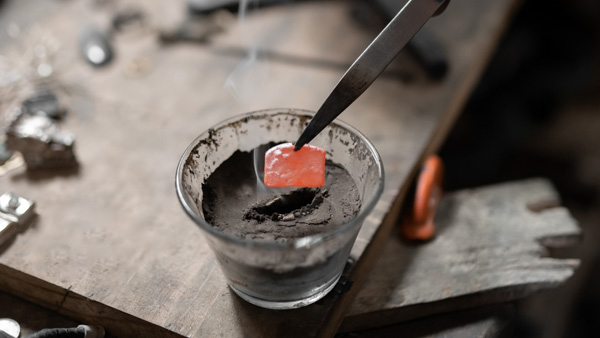 Image: An ingot of silver being heated. 