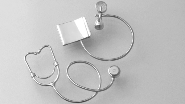 Image: Silver trinkets representing medical equipment. 