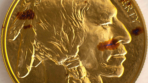 Image: Copper spots on a gold coin